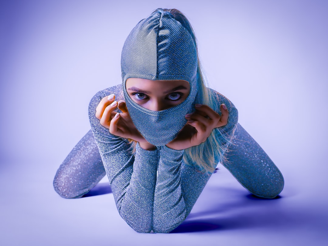 Woman in a shiny silver hooded outfit with mask